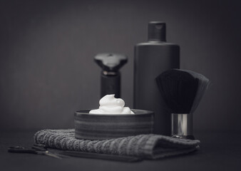 Fototapeta na wymiar A set of items for shaving a beard on a black background.