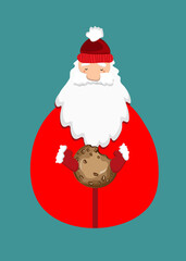 santa claus holding cookie on blue background