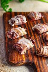 dates in bacon smoked meat dry-cured fresh delicious snack healthy meal food snack on the table copy space food background rustic top view