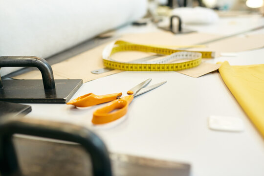 Tailor tools and materials on table in dress-making workshop horizontal shot