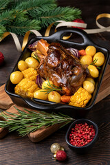Pork shank knuckle with baked potatoes and corn, festive food with Christmas New Year decor - obrazy, fototapety, plakaty