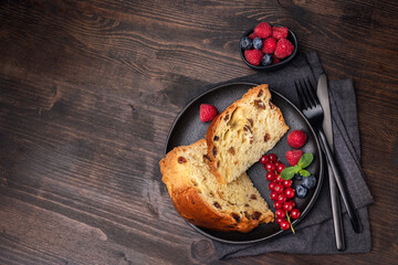 Traditional Italian Christmas fruitcake panettone with raisins and candied fruits. Holiday food for...