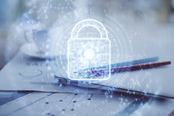 Double exposure of desktop with computer and lock icon hologram. Concept of data safety.