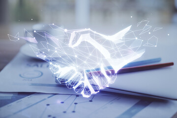 Desktop computer background in office and handshake hologram drawing. Double exposure. Pertnership concept.