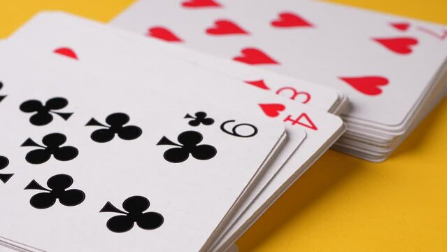Closeup of plating cards layered down on a yellow background