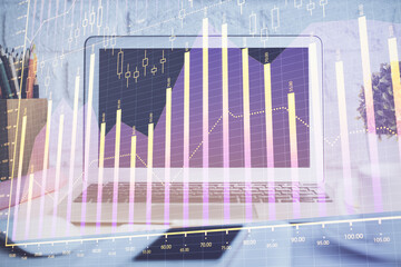 Forex graph hologram on table with computer background. Multi exposure. Concept of financial markets.