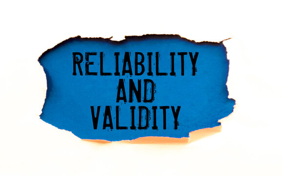 A sign with the inscription Reliability and Validity on the table with office supplies
