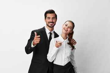 Man and woman smile with teeth business in business attire looking into camera on white insulated background hands big up. Stylish business concept paired between employees startup copy place