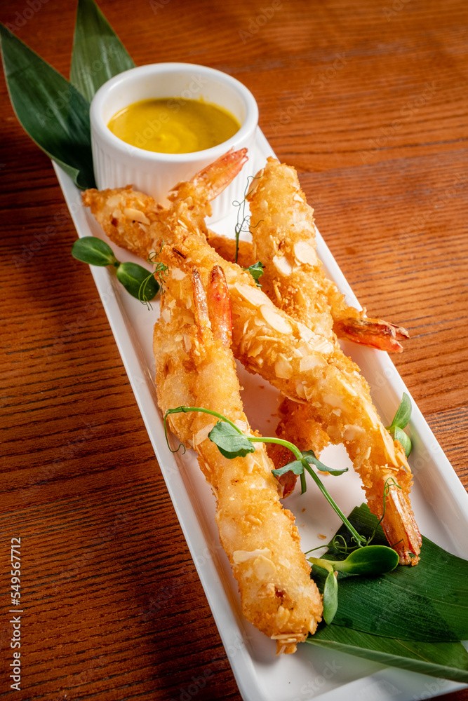 Sticker shrimp tempura with sauce on the wooden table