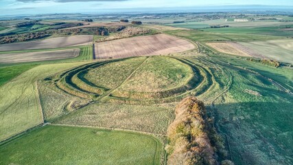 Aerial shot of an iron age hill fort Barbury castle in Wiltshire, England © Jonnywhitters/Wirestock Creators