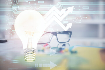Bulb drawing with glasses on the table background. Idea concept. Double exposure.