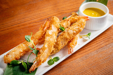 Shrimp tempura with sauce on the wooden table