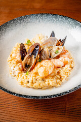 seafood risotto on the wooden background