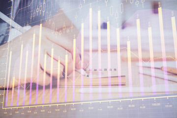 Multi exposure closeup hands with stock market forex graph.