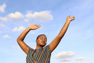 Black woman with her arms lifted