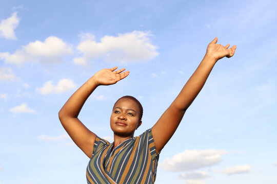 Black Woman with hands lifted to the sky