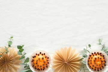 Christmas border, copy-space. Fragrant pomander balls handmade from tangerines with cloves....