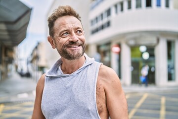 Middle age man smiling confident at the city