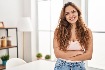 Fototapeta premium Young beautiful hispanic woman smiling confident standing with arms crossed gesture at home