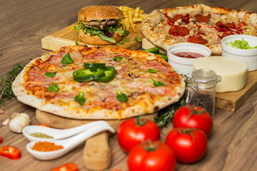 Pizza and hamburger on wooden background
