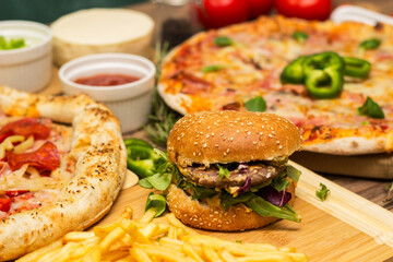 Pizza and hamburger on wooden background
