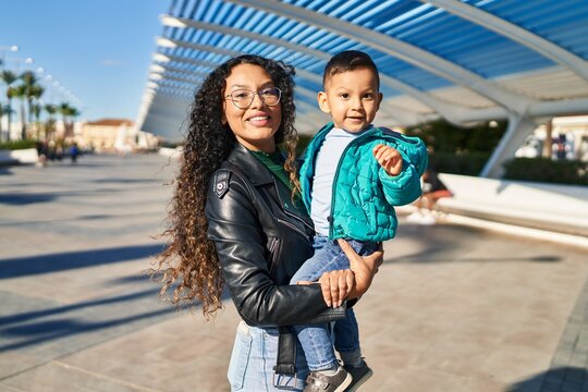 Mother and son hugging each other standing at street