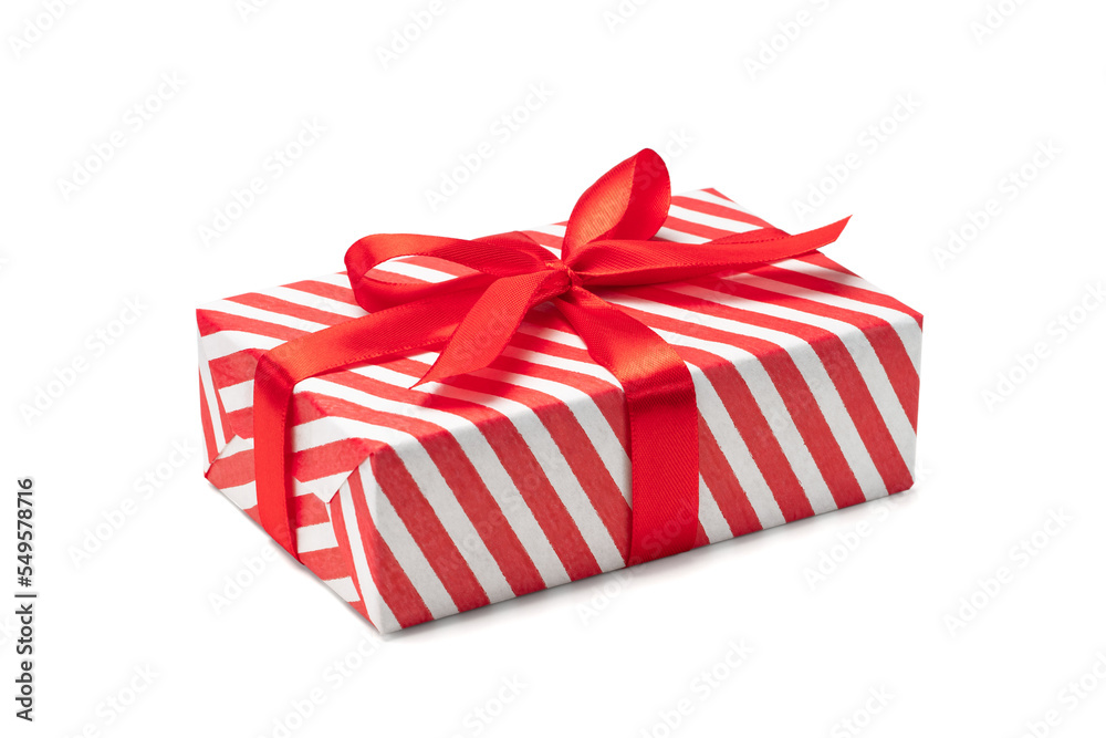 Wall mural close up shot of present box wrapped in red and white striped paper and decorated with a bow, isolat