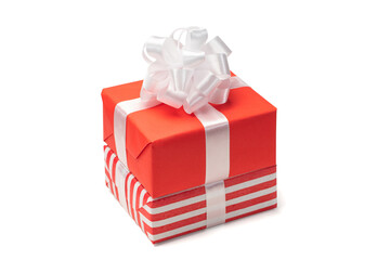 Close up shot of pile of two gift boxes wrapped in red and striped paper isolated and decorated with satin ribbon bows, isolated over white background