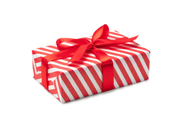 Close up shot of present box wrapped in red and white striped paper and decorated with a bow, isolated on white background - 549578716