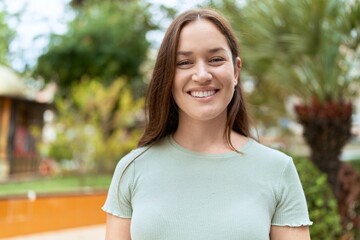 Young beautiful woman smiling confident standing at park