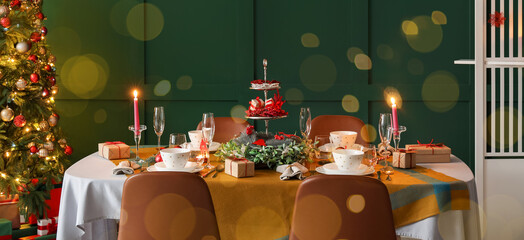Romantic table setting for Christmas dinner at home in evening