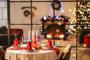 Stylish table setting for Christmas dinner at home in evening