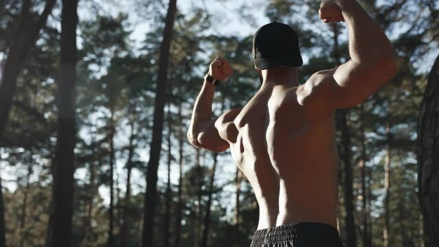 Sportsman shows off his perfect body, showing steel muscles