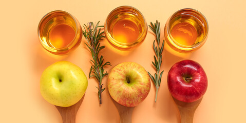 Composition with ripe apples, glasses of fresh juice and rosemary on beige background, top view
