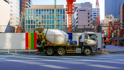 Concrete mixer car parked at the gate of construction site