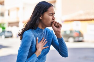 Young african american woman coughing at street