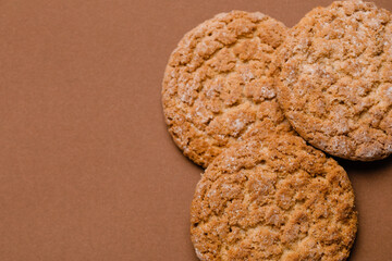 Delicious cookies on brown background