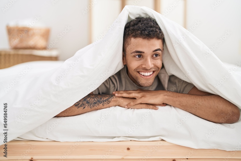 Sticker african american man lying on bed covering with bedsheet at bedroom