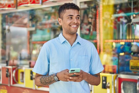 African american man smiling confident using smartphone at street market
