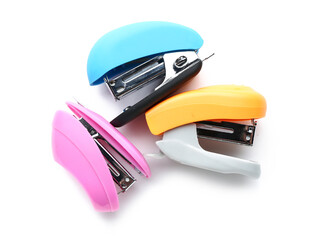 Three colorful staplers isolated on white background