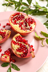 Plate with fresh pomegranates, closeup
