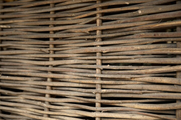 Wicker wooden fence as background, closeup