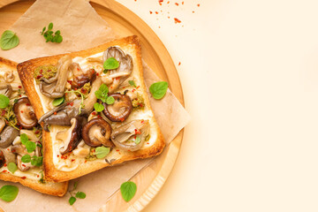 Wooden plate of delicious toasts with cream cheese, mushrooms and pesto sauce on color background, closeup