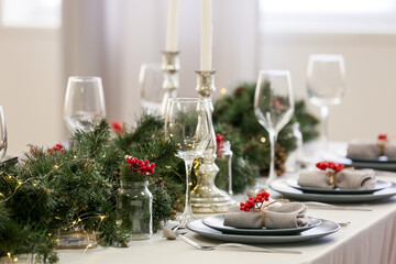 Christmas table setting with fir branches and rowan in dining room, closeup