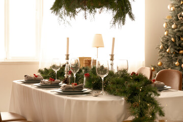 Christmas table setting with fir branches and rowan in dining room