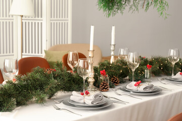 Christmas table setting with fir branches and rowan in dining room