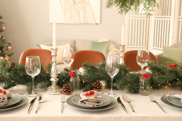 Christmas table setting with fir branches and rowan in dining room