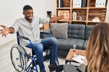 African american man doing therapy sitting on wheelchair looking at the camera smiling with open arms for hug. cheerful expression embracing happiness.