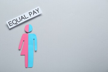 Equal pay concept. Human paper figure as male and female halves against light grey background, flat...