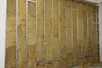 Wall with metal studs and insulation material indoors